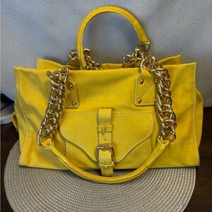 BY BIOS butter yellow rectangle bag with chunky gold accents.
